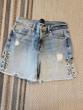 Light Blue Distressed Denim Shorts with Silver Eyelet Accents